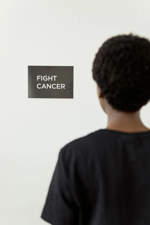 a young boy standing in front of a white wall, by Dan Frazier, unsplash contest winner, visual art, medical labels, fighter, tumors, kara walker