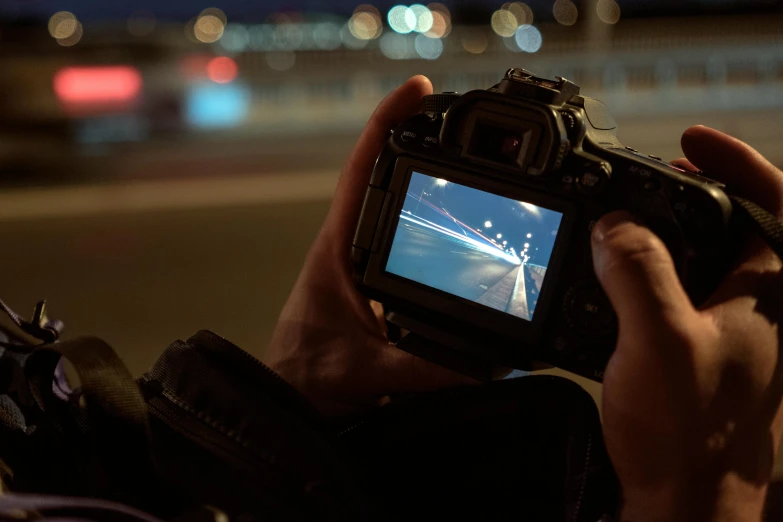 a person taking a picture with a camera, a picture, by Eglon van der Neer, pexels contest winner, night time footage, over the shoulder view, high speed camera, dslr high resolution