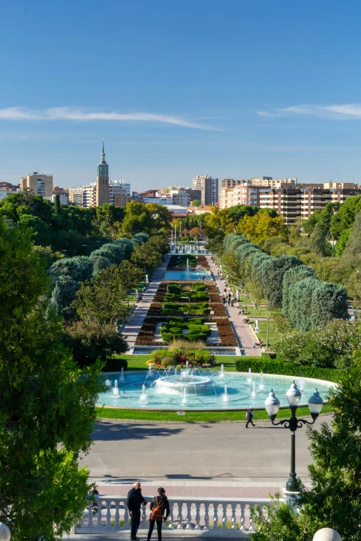 a view of a city from the top of a hill, gardens and fountains, madrid, featuring flowing fountains, an award winning