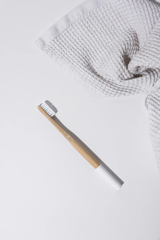 a toothbrush and a towel on a white surface, of bamboo, thumbnail, detailed product image, platinum