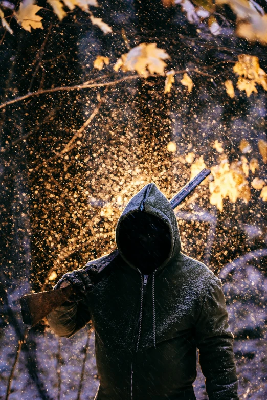 a man standing in the snow with a knife in his hand, an album cover, inspired by Attila Meszlenyi, pexels contest winner, cyberpunk in foliage, muzzle flash, clothed in hooded, dust particle