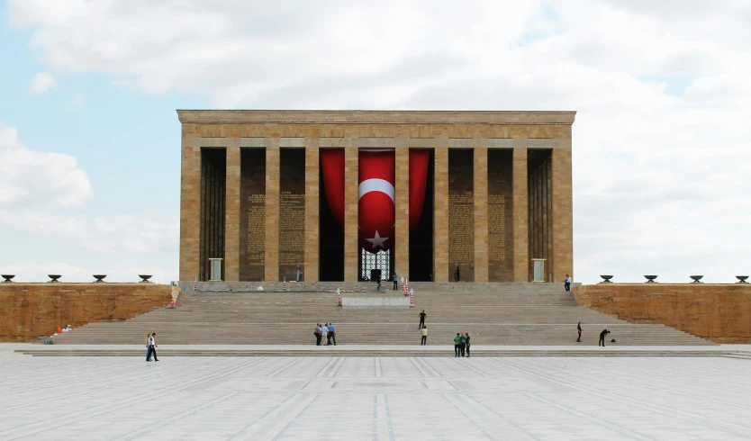 a group of people standing in front of a building, a marble sculpture, by Yasar Vurdem, pexels contest winner, hurufiyya, tombs, 2. sigara aşırmak, art deco stadium, revolutionary