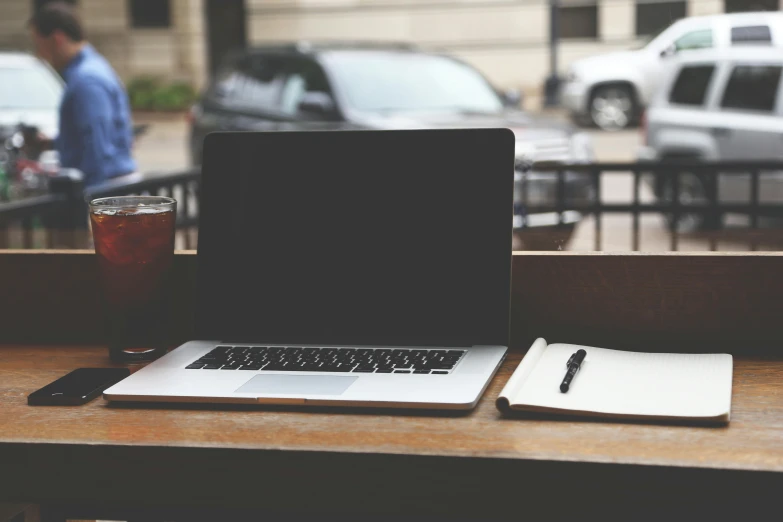 a laptop computer sitting on top of a wooden table, by Carey Morris, unsplash, sitting in a cafe, 2 5 6 x 2 5 6 pixels, grungy, screenwriter