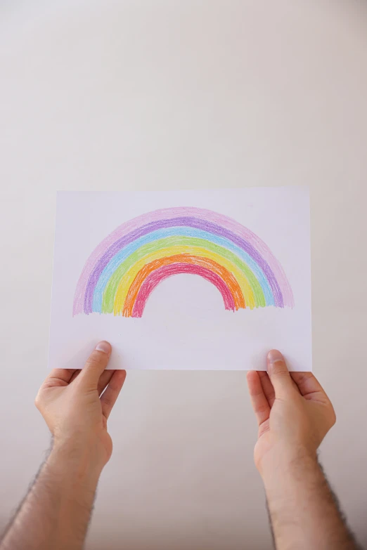 a person holding a piece of paper with a rainbow drawn on it, a child's drawing, by Nicolette Macnamara, pexels, made of silk paper, art print, wall art, stippling art