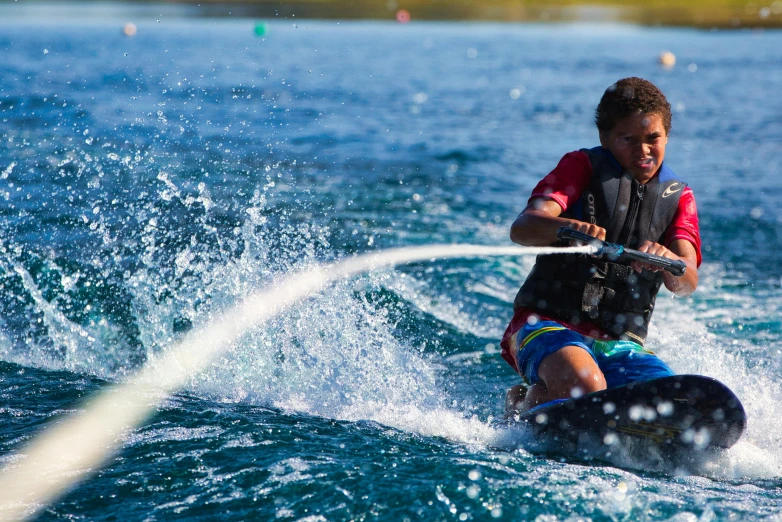 a man riding a wake board on top of a body of water, avatar image