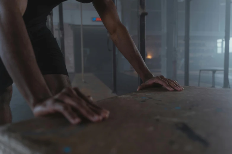 a woman standing on top of a wooden table, by Adam Marczyński, pexels contest winner, realism, in a gym, extreme hand detail, climbing, faded and dusty