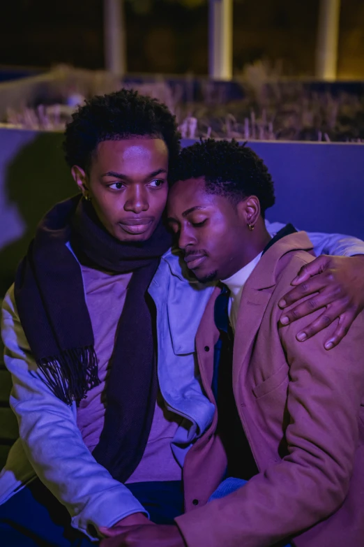 two men sitting next to each other on a bench, an album cover, trending on pexels, romanticism, ( ( dark skin ) ), embracing, brightly colored, ( ( theatrical ) )