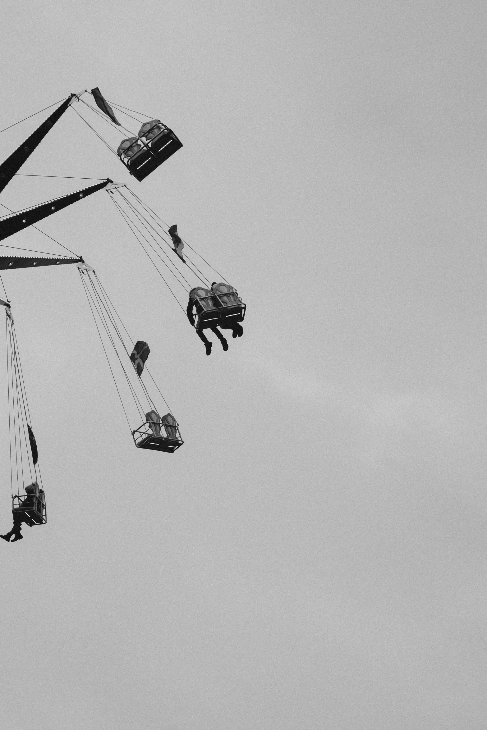 a black and white photo of a carnival ride, a black and white photo, pexels contest winner, aestheticism, 2 5 6 x 2 5 6, jump, sitting in a crane, gondolas