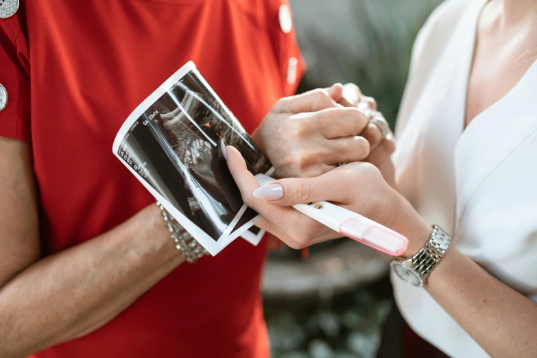 a close up of a person holding a toothbrush, a polaroid photo, by Julia Pishtar, pexels contest winner, happening, pregnant belly, holding hands, local conspirologist, al fresco