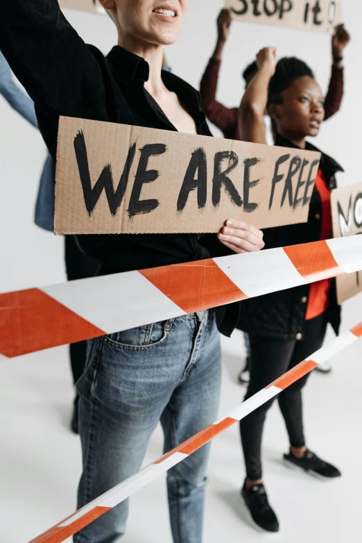 a group of people holding signs behind a barricade, pexels, artwork about a road to freedom, photo of a model, video, clean background