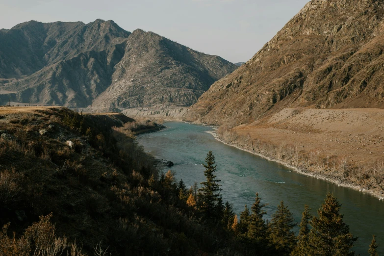 a view of a river with mountains in the background, by Emma Andijewska, pexels contest winner, hurufiyya, giant river, high view, ash thorp khyzyl saleem, white