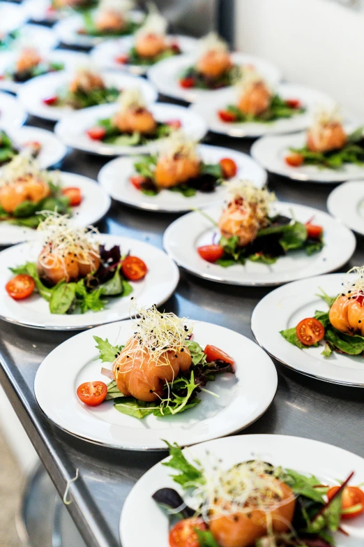 a table topped with lots of white plates filled with food, salad, on a plate, delicious food, plating