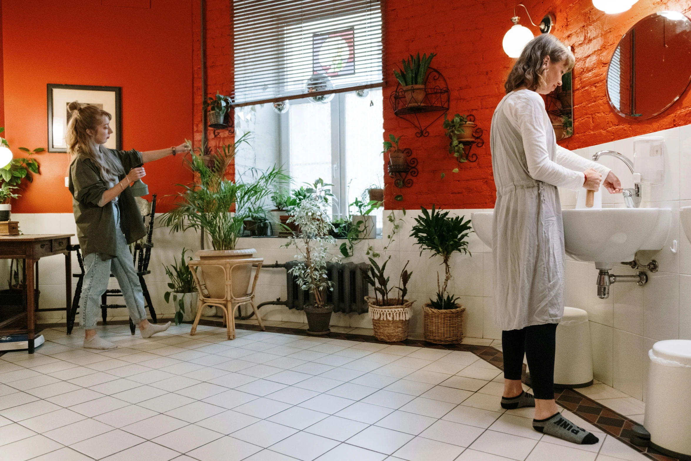 a woman standing in a bathroom next to a sink, pexels contest winner, plants on pots and on the walls, people at work, people walking around, nursing