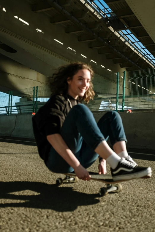 a woman sitting on a skateboard in a parking lot, a picture, by Tom Bonson, happening, sitting under bridge, lachlan bailey, profile image