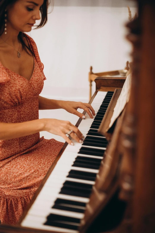 a woman in a dress playing a piano, trending on pexels, australian, subtle detailing, brown, ornately dressed