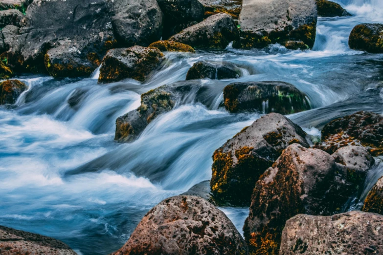 a river running through a lush green forest, pexels contest winner, hurufiyya, waves crashing at rocks, thumbnail, blue, chocolate river