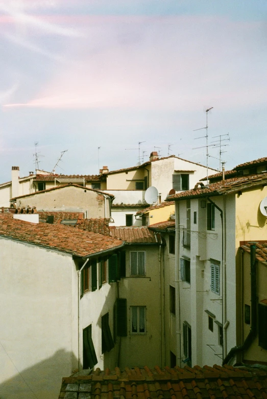 a group of buildings sitting next to each other, inspired by Eliseu Visconti, pexels contest winner, renaissance, summer afternoon, rooftop, pale yellow sky, medium format. soft light