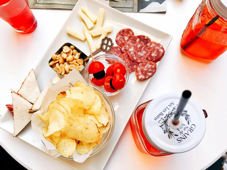 a close up of a plate of food on a table, a photo, by Carey Morris, pexels contest winner, realism, white and red color scheme, snacks, 🦩🪐🐞👩🏻🦳, chianti molotov cocktails