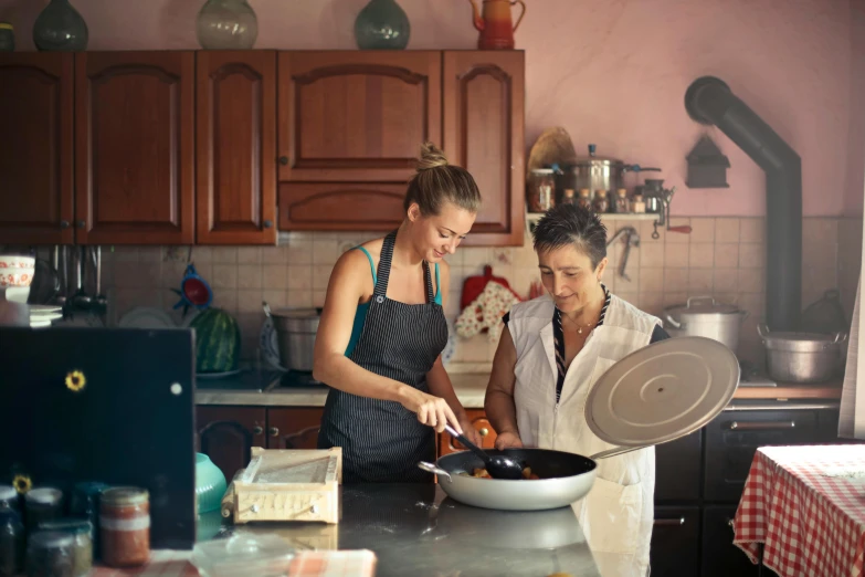 two women standing in a kitchen preparing food, pexels contest winner, fan favorite, italian, still frame, profile image