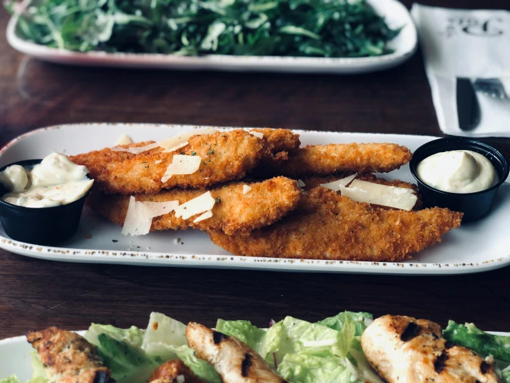 a close up of a plate of food on a table, fins, background image, cheesy, greens)