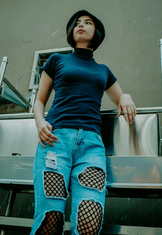 a woman sitting on the back of a truck, inspired by Elsa Bleda, pexels contest winner, renaissance, wearing fishnets, blue tight tshirt, worn pants, with a bob cut