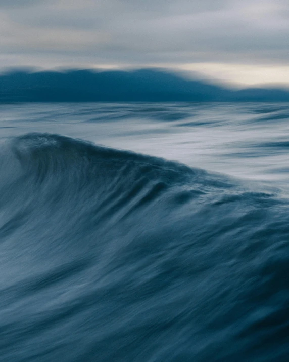 a large wave in the middle of a body of water, by Adam Marczyński, desaturated blue, today\'s featured photograph 4k, soft vinyl, ilustration