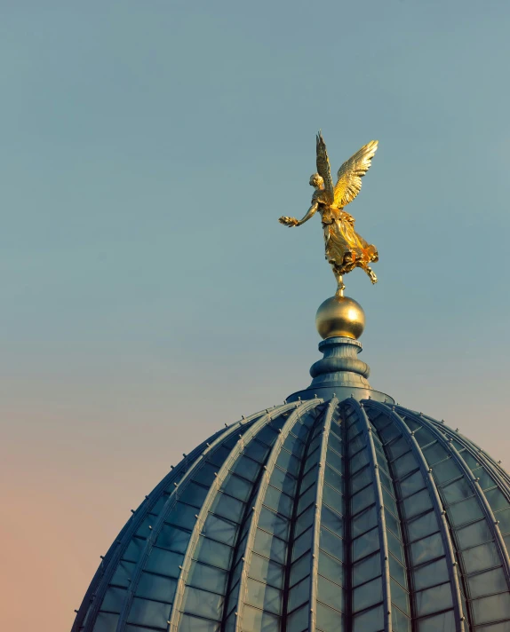 a golden angel on top of a domed building, pexels contest winner, berlin secession, lgbtq, 2 0 2 2 photo