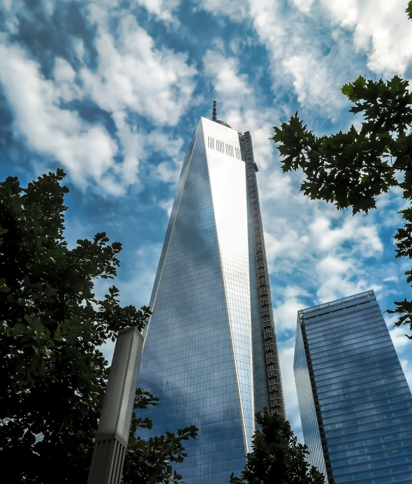 a very tall building sitting in the middle of a city, by Carey Morris, pexels contest winner, modernism, world trade center twin towers, slide show, today\'s featured photograph 4k, city buildings on top of trees