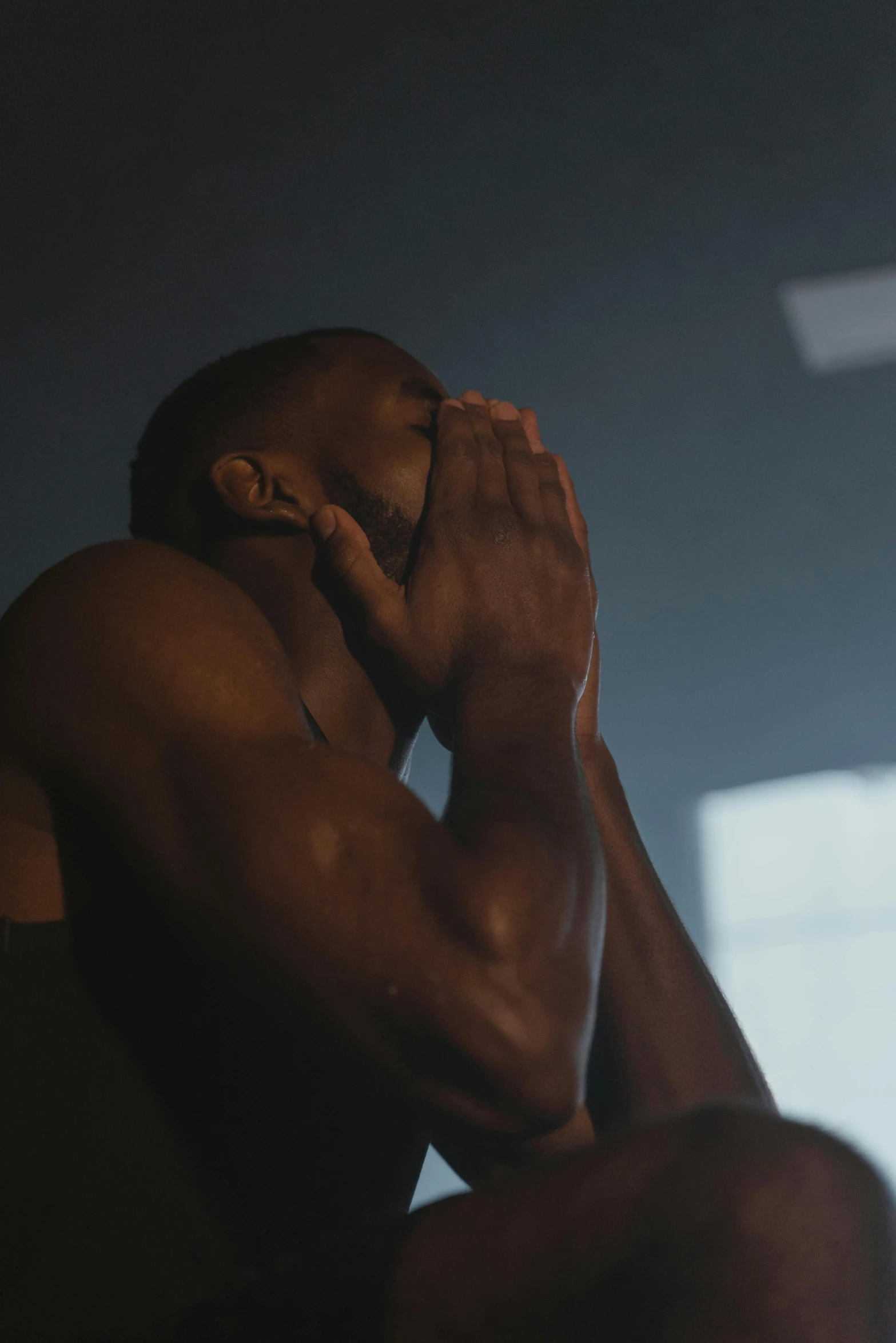 a man sitting in front of a laptop computer, an album cover, inspired by Terrell James, pexels contest winner, crying engine, in a gym, pray, 4 k hd film still