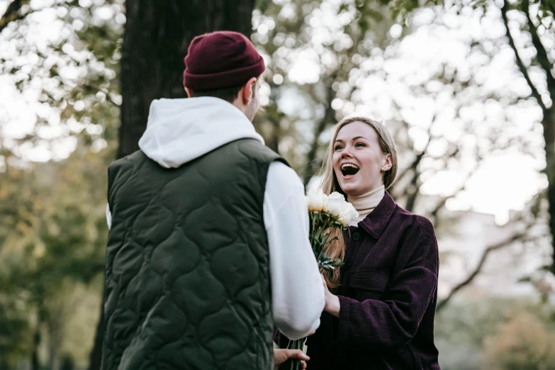 a man giving a woman a bouquet of flowers, by Niko Henrichon, pexels contest winner, shouting, in a park, sydney hanson, emma watson with anxious