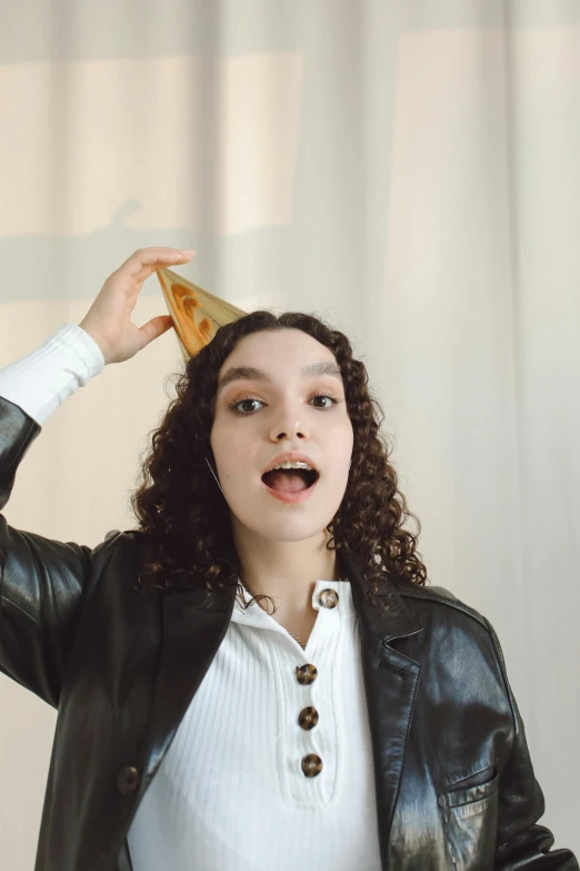 a woman holding a slice of pizza up to her head, an album cover, by Winona Nelson, trending on pexels, renaissance, rebecca sugar, pyramid hoodvisor, she wears leather jacket, bella poarch