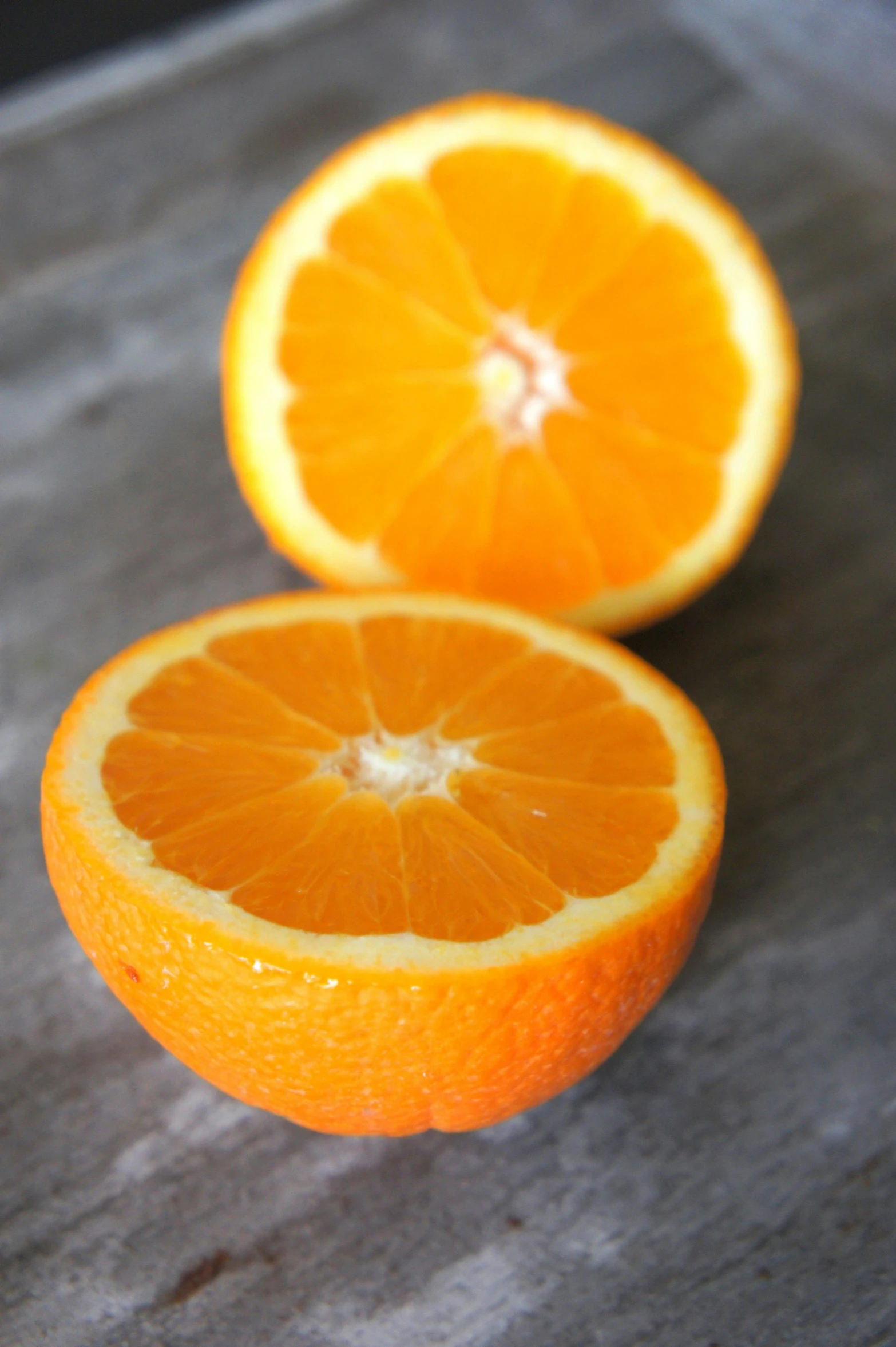 an orange cut in half on a cutting board, award-winning crisp details”, “organic, soft, slightly smirking