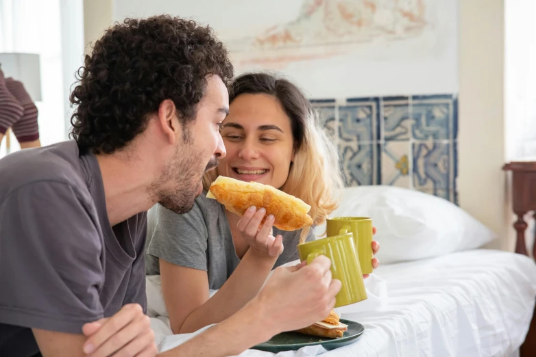 a man and a woman sitting on a bed eating doughnuts, pexels contest winner, renaissance, eating garlic bread, manuka, hot dog, profile image