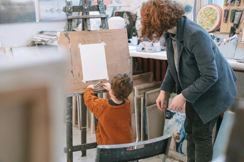 a man standing next to a little boy in a room, a child's drawing, pexels contest winner, arbeitsrat für kunst, stands at her easel, al fresco, thumbnail, rectangle