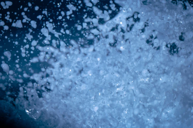 a close up of water with bubbles coming out of it, unsplash, digital art, blue crashing waves, splash image, (night), full frame image