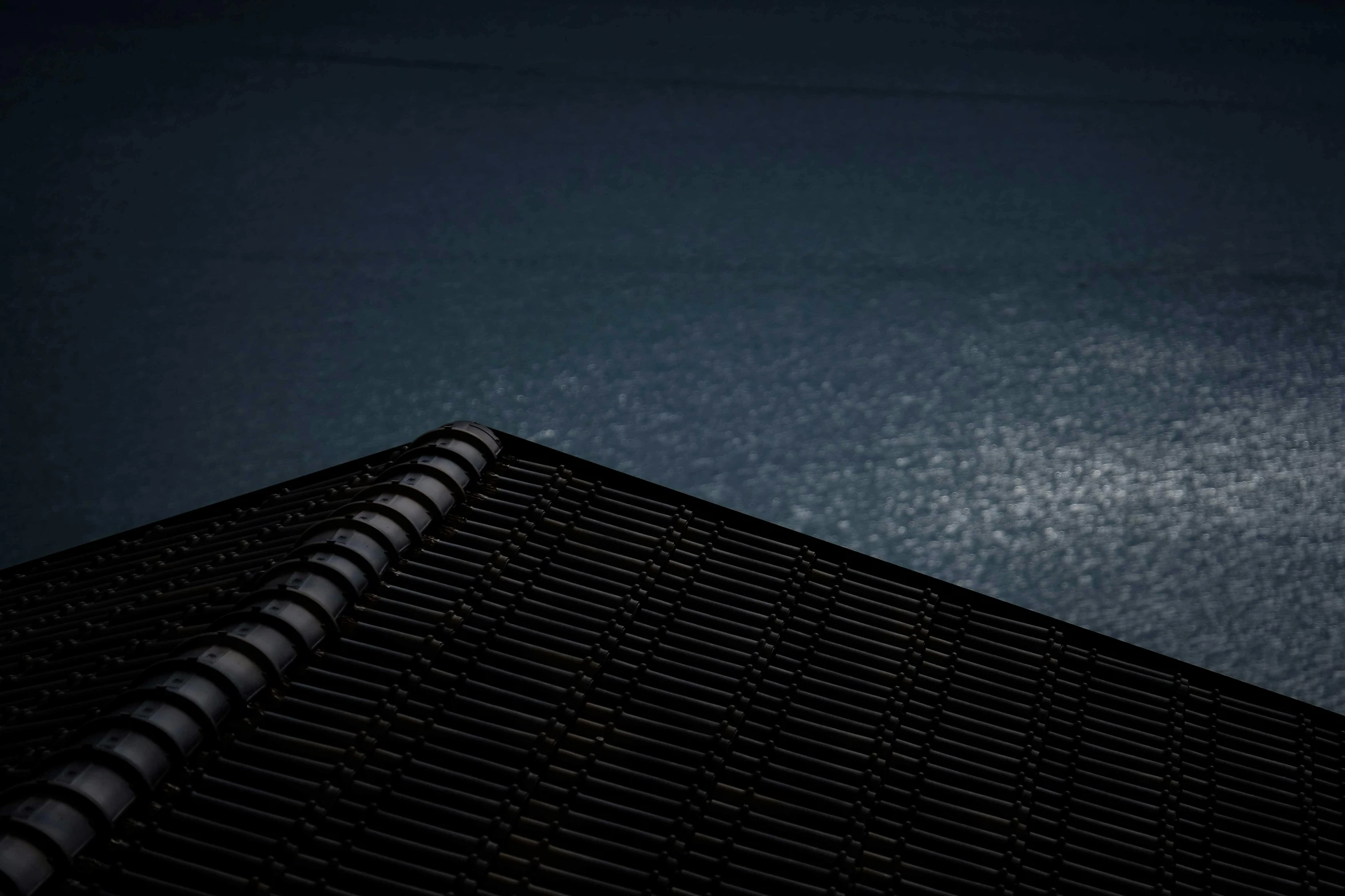 a bird sitting on top of a roof next to a body of water, an album cover, inspired by Andreas Gursky, unsplash contest winner, minimalism, dark moody backlighting, notebook, poolside, shot on sony a 7