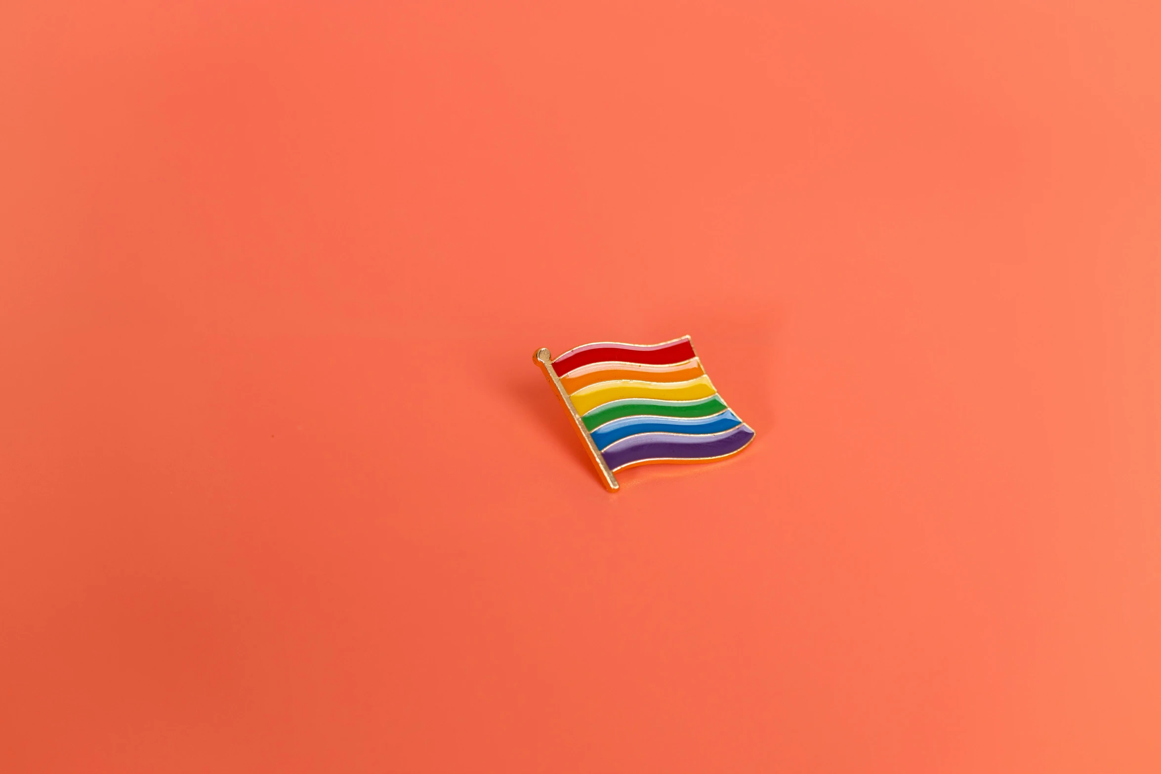 a rainbow flag on a pink background, trending on pexels, pins, orange color, miniature product photo, 15081959 21121991 01012000 4k