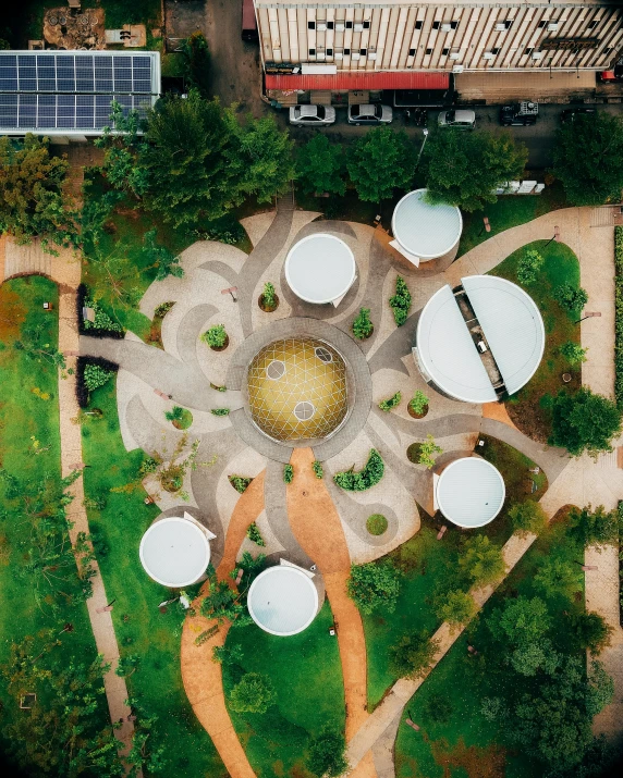 an aerial view of a park with tables and umbrellas, inspired by Buckminster Fuller, unsplash contest winner, land art, shipibo, artwork of a building, star roof, te pae