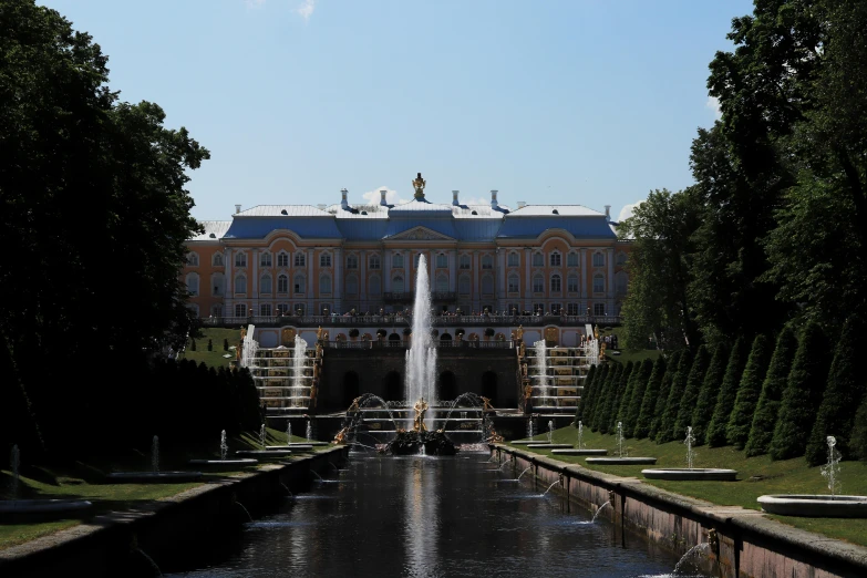 a large building with a fountain in front of it, an album cover, inspired by Konstantin Vasilyev, pexels contest winner, rococo, canals, reuters, summer day, thumbnail