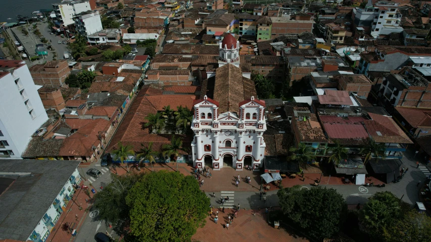 a view of a city from a bird's eye view, an album cover, by Luis Miranda, pexels, quito school, white buildings with red roofs, religious, carnaval de barranquilla, shot with sony alpha 1 camera