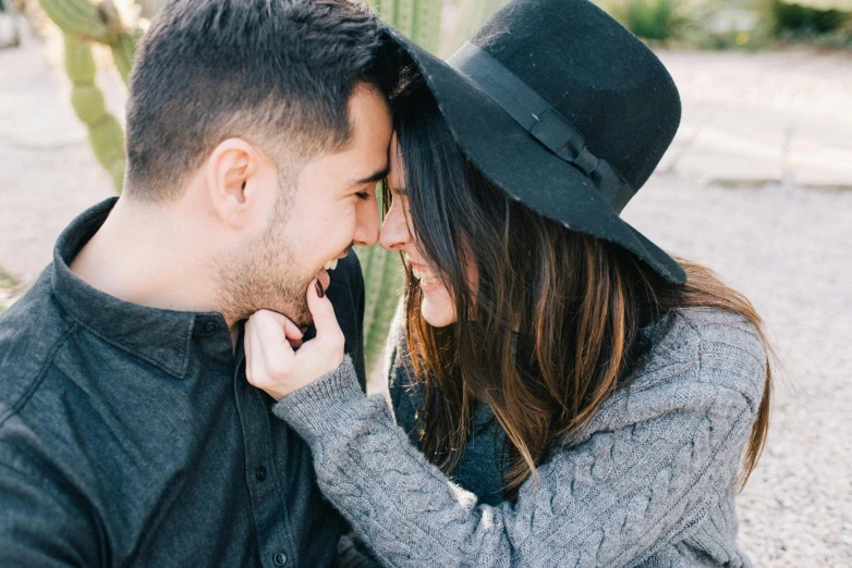 a man and a woman sitting next to each other, trending on pexels, romanticism, wearing a cute hat, avatar image, up close shot, playful