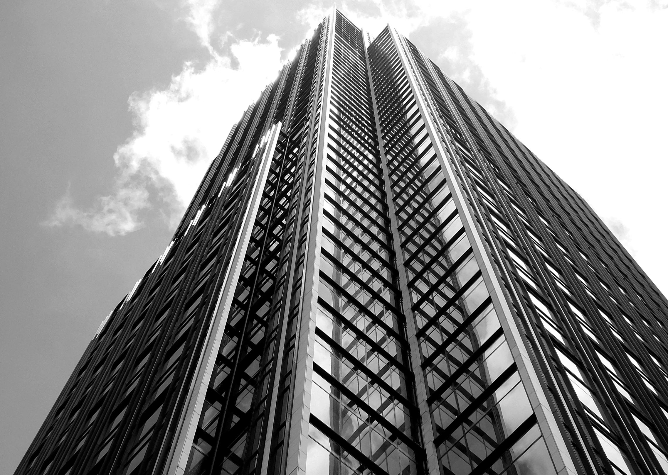 a black and white photo of a tall building, inspired by Cheng Jiasui, pexels contest winner, style of mirror\'s edge, gold, london architecture, architecture carved for a titan