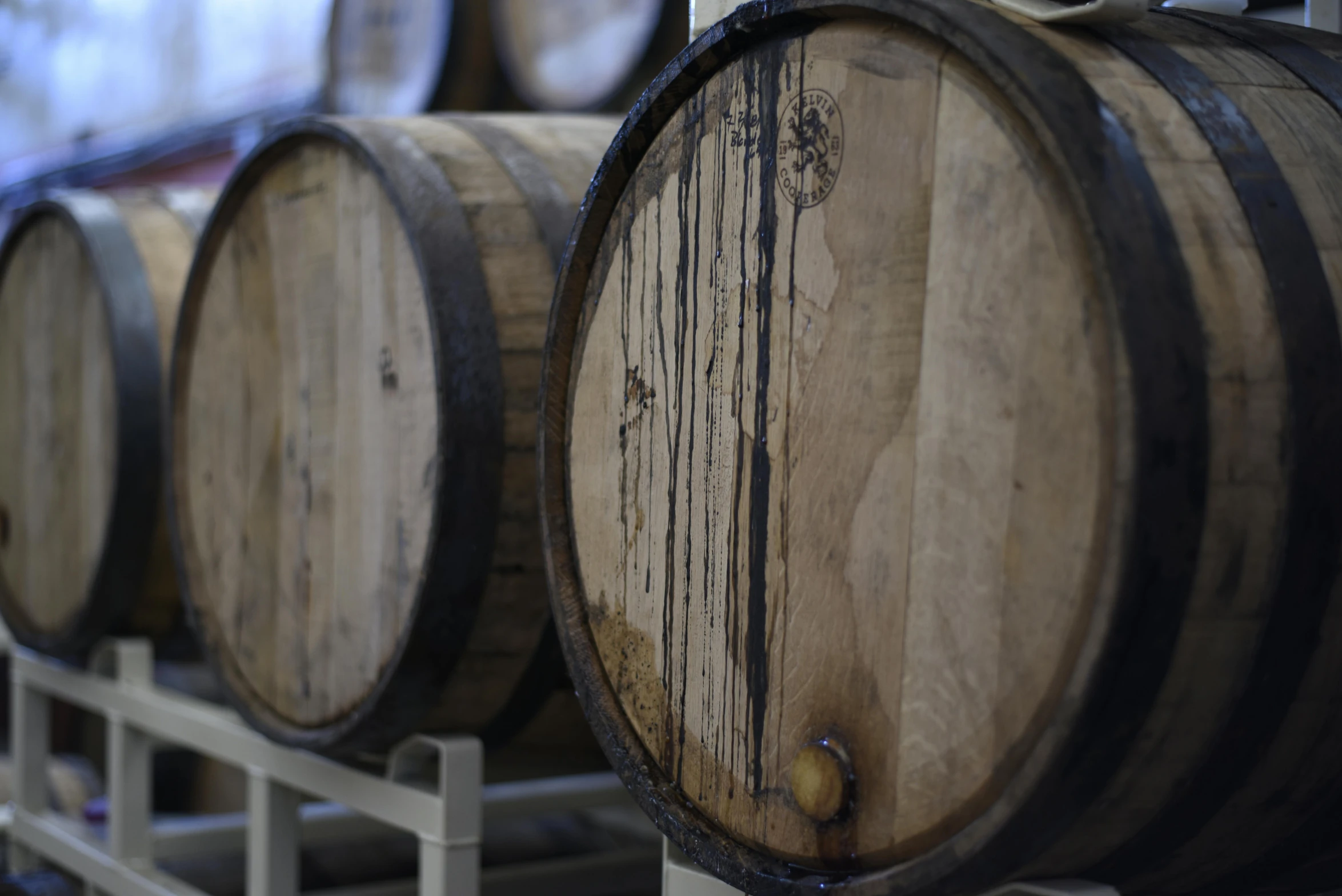 a bunch of wooden barrels sitting on top of a rack, a portrait, unsplash, profile image, close up image, version 3, uncropped