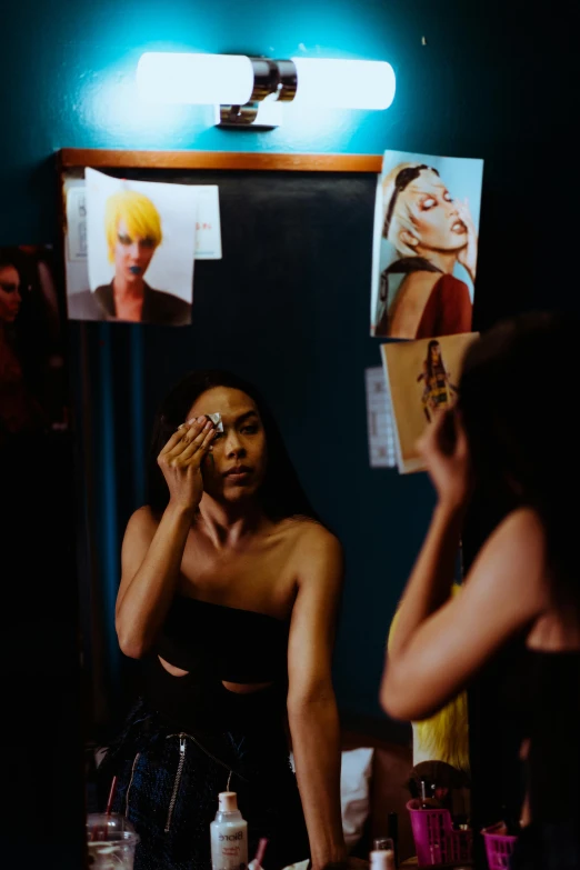 a woman that is standing in front of a mirror, a photo, inspired by Nan Goldin, trending on pexels, ru paul\'s drag race, tessa thompson inspired, fashionweek backstage, slide show