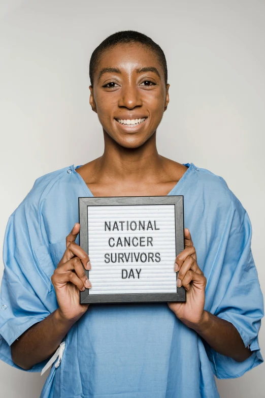 a woman holding a sign that says national cancer survivors day, pexels contest winner, renaissance, ashteroth, promo photo, ( ( theatrical ) ), q