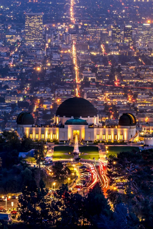 a view of a city at night from the top of a hill, a tilt shift photo, inspired by L. A. Ring, pexels contest winner, art nouveau, glowing temple in the distance, hollywood promotional image, parks and monuments, set in observatory at night