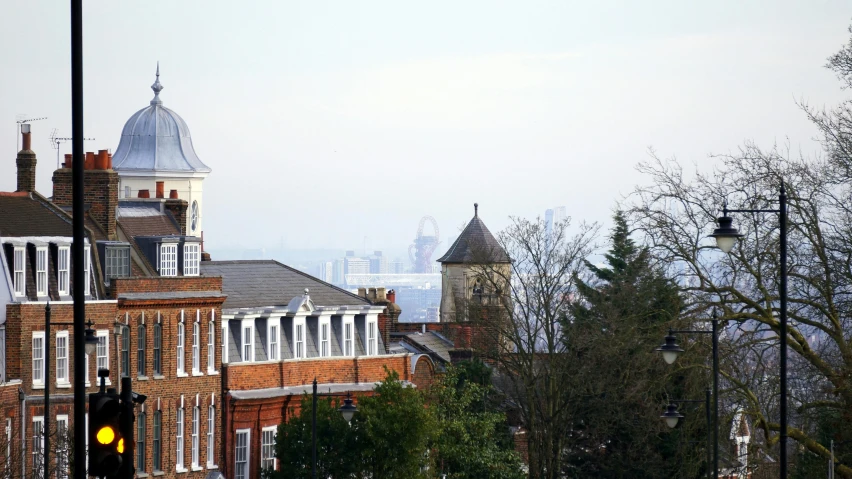 a view of a city from the top of a hill, inspired by Christopher Wren, unsplash, barbizon school, trees in foreground, shot from roofline, seaview, barnet