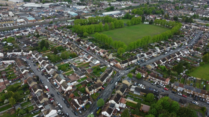 an aerial view of a city with lots of houses, by Julian Allen, shutterstock, barnet, 4k footage, 1 8 mm wide shot, detailed street