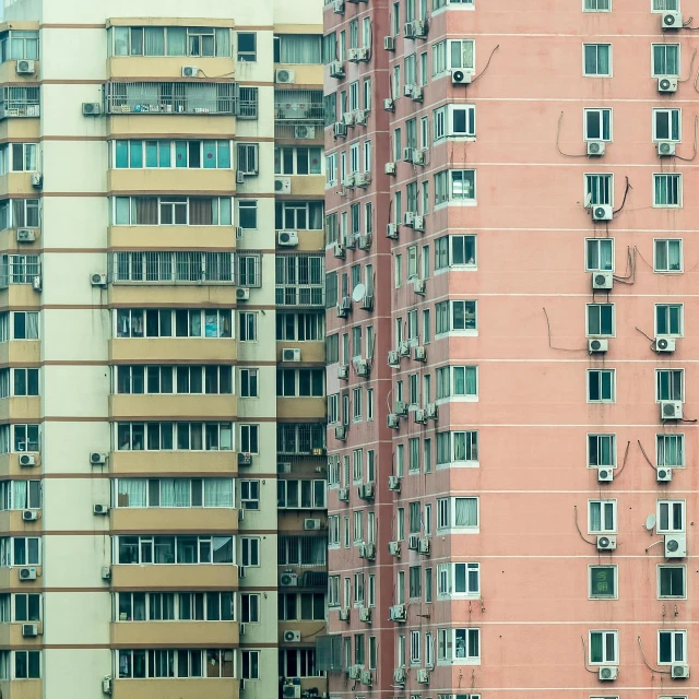 a couple of tall buildings next to each other, a photo, inspired by Zhang Kechun, pexels contest winner, hyperrealism, air conditioner, pink concrete, parapets, a small