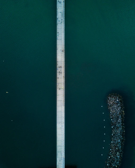 an overhead view of a boat in a body of water, on a bridge, dark green water, thumbnail, best photo